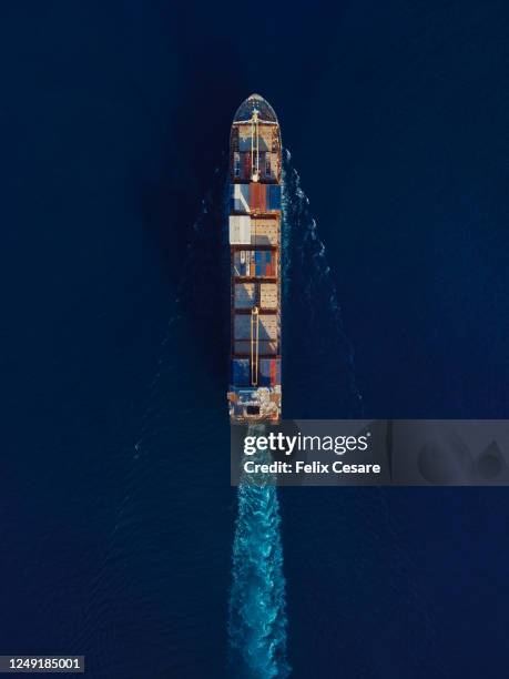 aerial view of a cargo container ship at sea - global trade war stock pictures, royalty-free photos & images