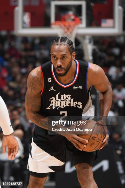 Kawhi Leonard of the LA Clippers handles the ball during the game against the Oklahoma City Thunder on March 23, 2023 at Crypto.Com Arena in Los...