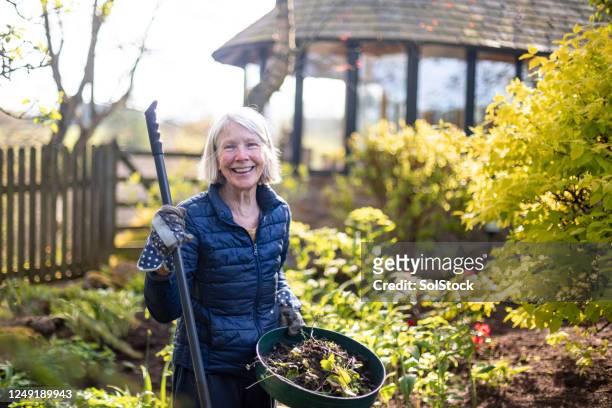 gardening with a smile - senior women gardening stock pictures, royalty-free photos & images
