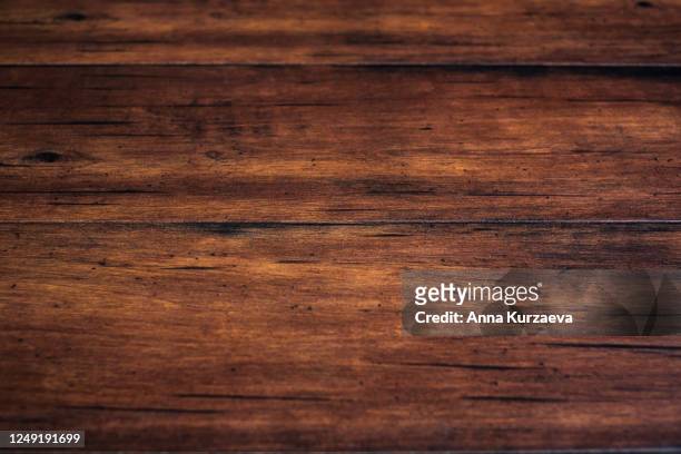 brown coloured wooden scratched background. natural background. - tavolo foto e immagini stock