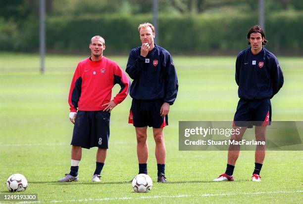 Freddie Ljungberg, Dennis Bergkamp and Robert Pires of Arsenal during an Arsenal training session on May 7, 2004 in St. Albans, England.