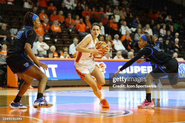 Bowling Green Falcons guard Amy Velasco drives to the basket between Memphis Tigers forward Aliyah Green and Memphis Tigers guard Tanyuel Welch...