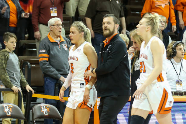 Bowling Green Falcons guard Elissa Brett , left, is assisted off of the court after an altercation with Memphis Tigers guard Jamirah Shutes during...