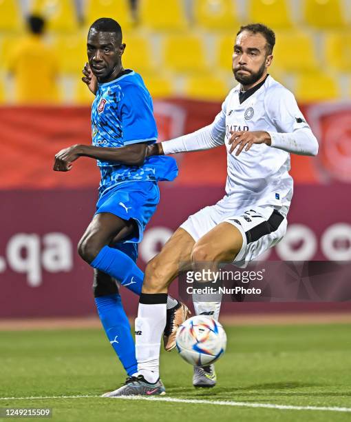 Bahaa Mamdouh Ellethy of Al Sadd SC and Mohammed Muntari of Al Duhail SC battle for the ball during the Ooredoo Cup semifinal between Al Duhail SC...