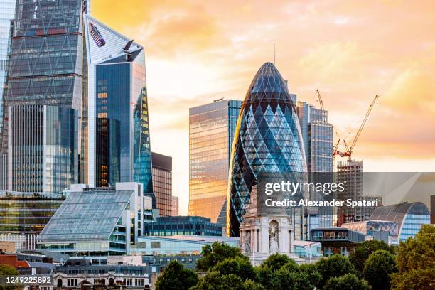 city of london skyline with modern skyscrapers at sunset, uk. - gherkin london stock pictures, royalty-free photos & images