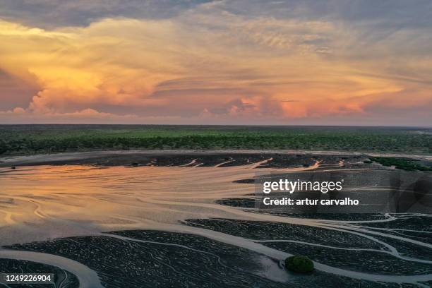 epic sunset and dramatic reflections the water - low tide stock pictures, royalty-free photos & images