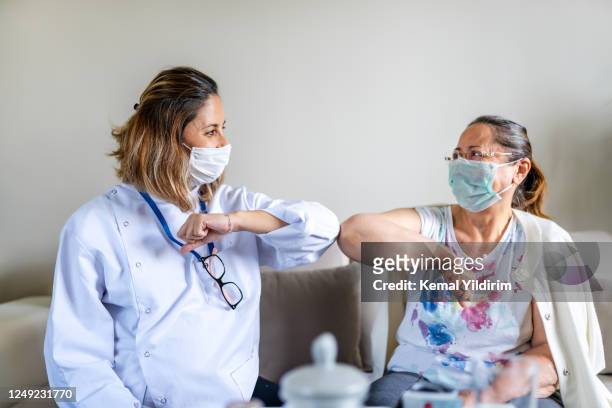 caregiver at home visit during lockdown - patient safety stock pictures, royalty-free photos & images
