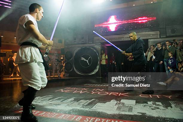 Cascade Demo Team members perform a Lightsaber fight at the Star Wars Saga release party at Virgin Megastore Champs-Elysees on September 13, 2011 in...