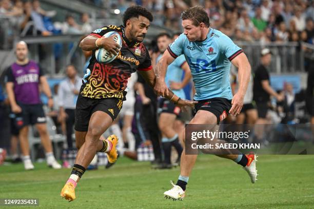 Chiefs' Emoji Narawa avoids a tackle by Waratahs' Michael Hooper during the Super Rugby match between the New South Wales Waratahs and Chiefs at the...