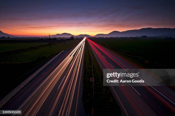lights on the highway - vehicle light stock pictures, royalty-free photos & images