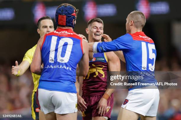 Dayne Zorko of the Lions exchanges words with Melbourne players during the 2023 AFL Round 02 match between the Brisbane Lions and the Melbourne...