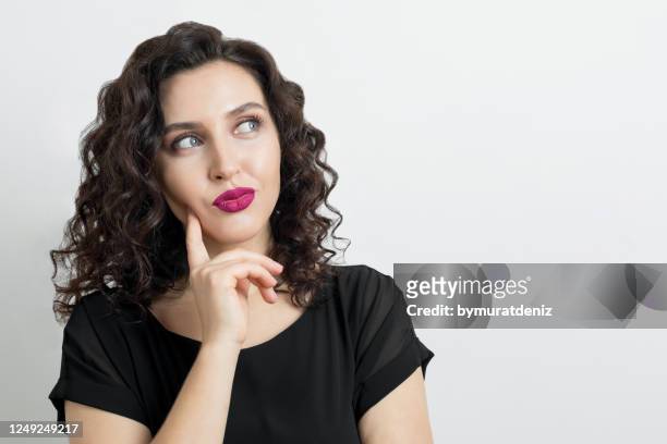 young woman thinking - suspicion stock pictures, royalty-free photos & images