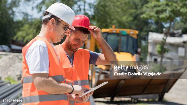 construction workers using modern technology - construction vehicle stock pictures, royalty-free photos & images