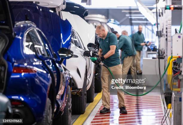 An employee fills an Aston Martin DBX sport utility vehicle with fuel on the final assembly line at the Aston Martin Lagonda Global Holdings Plc...