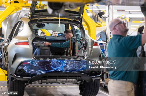 An employee places paperwork inside an Aston Martin DBX sport utility vehicle on the final assembly line at the Aston Martin Lagonda Global Holdings...