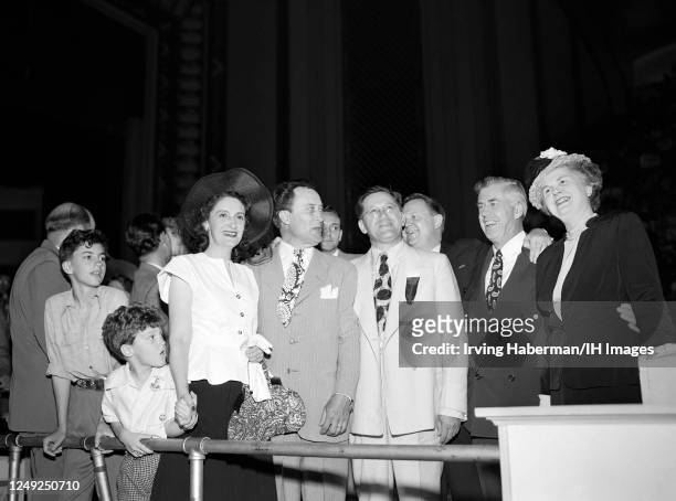 American politician, entertainer, businessman, and U.S. Senator from Idaho Glen H. Taylor , stands with his sons and wife Glen Arod, Gregory, Dora...