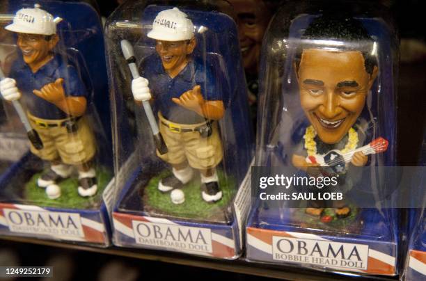 Commemorative toy bobbleheads depicting US President Barack Obama sit on the shelves of a souvenir store near Waikiki Beach in Honolulu, Hawaii,...