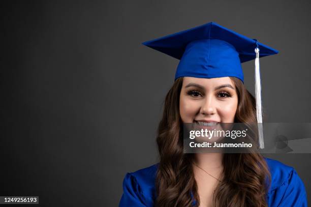 smiling young woman celebrating her graduation - graduation clothing stock pictures, royalty-free photos & images