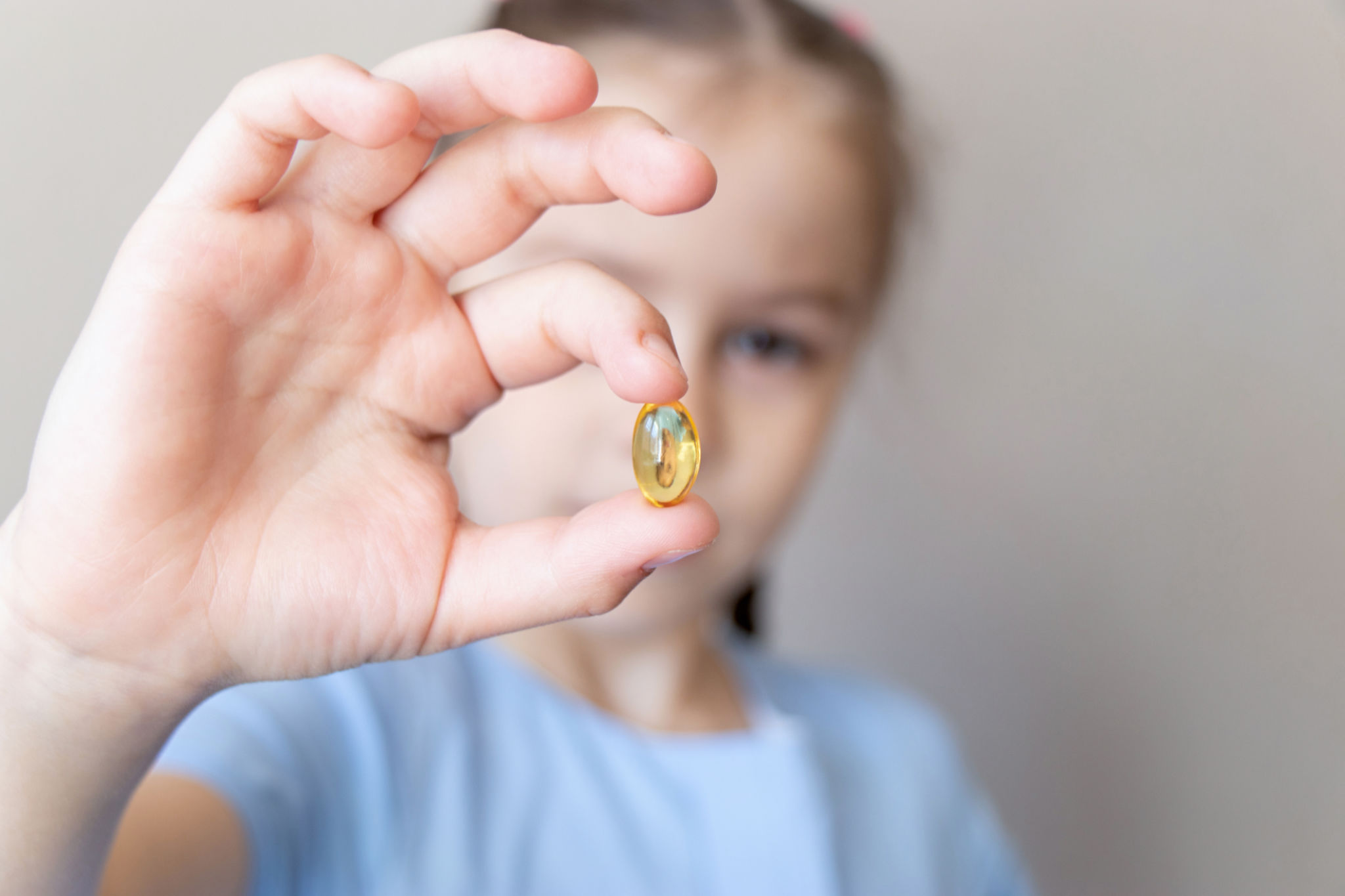 child taking vitamins