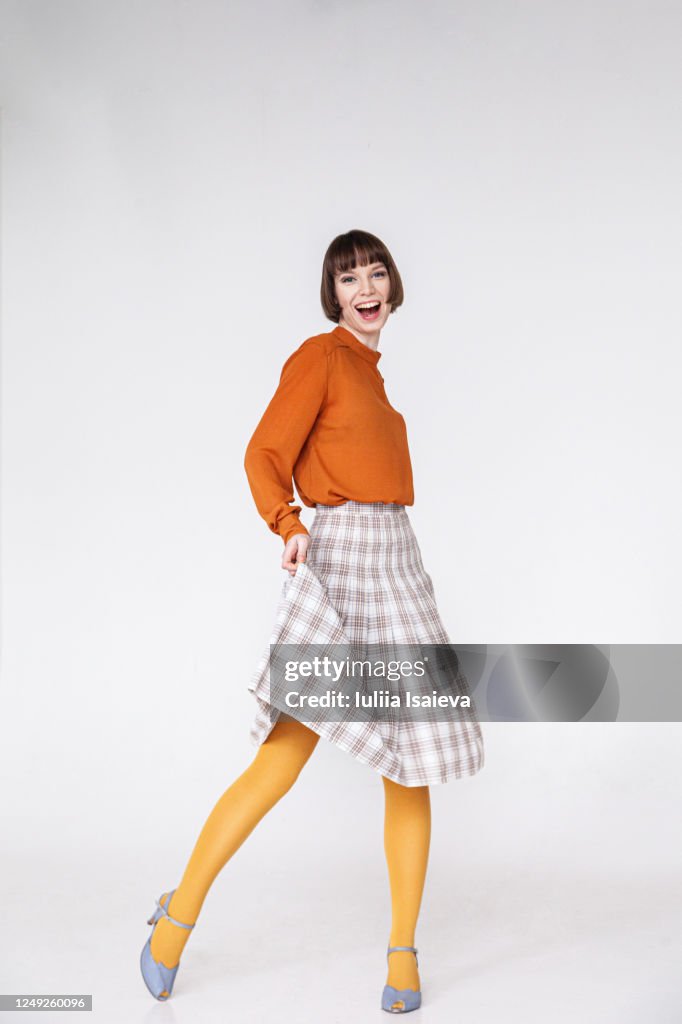 Happy female model in retro outfit