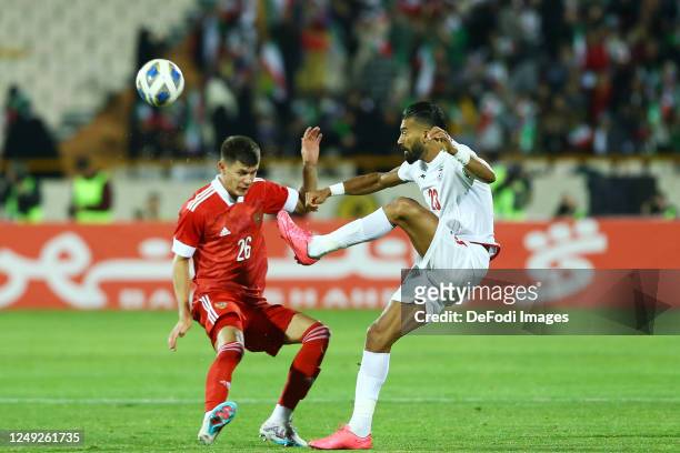 Ramin Rezaeian of Iran and Khlusevich Daniil of Russia battle for the ball during the International Friendly between Iran and Russia at Azadi Stadium...