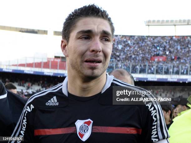 River Plate's goalkeeper Juan Pablo Carrizo cries after being relegated to second division after the Argentina's Promotion football match against...