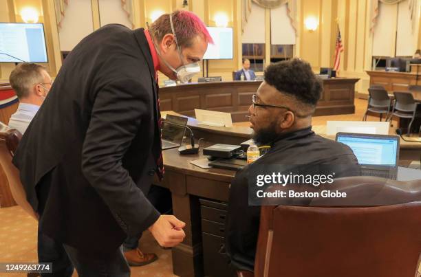 Somerville, MA Somerville City Councilors Jefferson Thomas JT Scott, left talking to City Councilor Willie Burnley Jr., in the City Council Chambers...