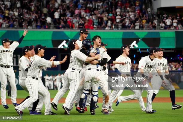 Shohei Ohtani of Team Japan celebrates with teammates on the field after Team Japan defeated Team USA in the 2023 World Baseball Classic Championship...