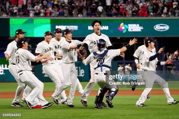 Shohei Ohtani of Team Japan celebrates with teammates on the field after Team Japan defeated Team USA in the 2023 World Baseball Classic Championship...