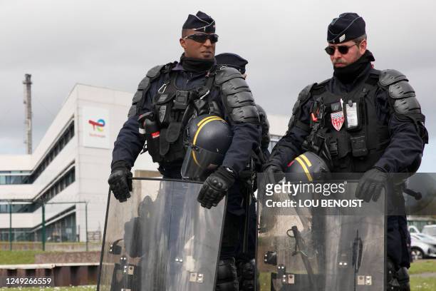 French Republican Security Corps police officers stand guard during a demonstration of Totalenergies striking employees outside the...