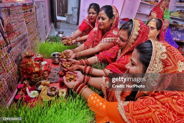 Women perform prayers during the celebrations of traditional 'Gangaur' festival, in Jaipur, Rajasthan, India, Friday, March 24, 2023.