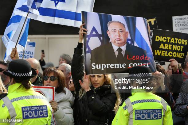 Protester holds a sign making Netanyahu look like a Chinese dictator at Downing Street on March 24, 2023 in London, England. Benjamin Netanyahu...