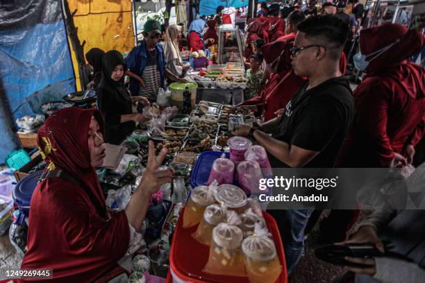 Indonesian Muslims buy food for breaking the fast at a Ramadan market known as Pasar Bedug in Palembang, Indonesia on March 24, 2023. Pasar Bedug is...