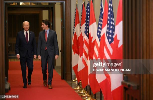 Canada's Prime Minister Justin Trudeau walks with US President Joe Biden after welcoming him at Parliament Hill in Ottawa, Canada, on March 24, 2023.