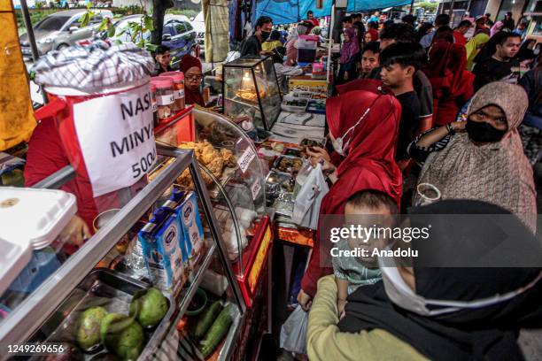 Indonesian Muslims buy food for breaking the fast at a Ramadan market known as Pasar Bedug in Palembang, Indonesia on March 24, 2023. Pasar Bedug is...