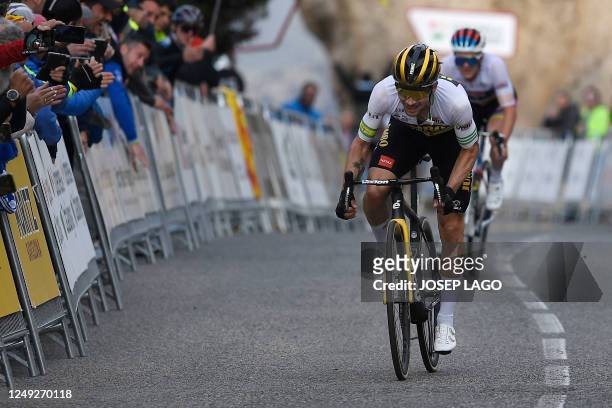 Stage winner Team Jumbo-Visma's Slovenian rider Primoz Roglic approaches the finish line followed by Team Soudal-Quick Step's Belgian rider Remco...