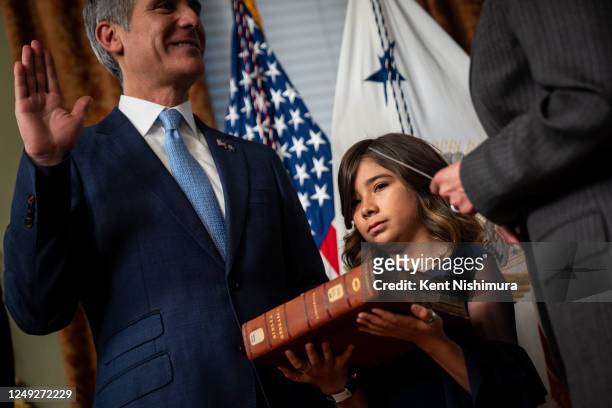 Maya Garcetti, daughter of Eric Garcetti holds a bible as Vice President Kamala Harris ceremonially swears-in Eric Garcetti as the Ambassador to...