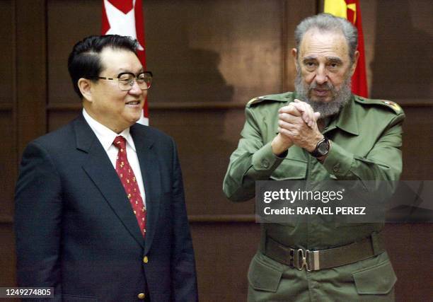 Cuban President Fidel Castro makes a gesture to the members of the Chinese delegation while standing next to Li Changchun, member of the Chinese...