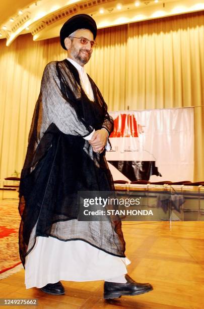 Sheikh Abdulaziz al-Hakim, number two in the Supreme Assembly of the Islamic Revolution in Iraq, walks across the stage after members of the first...