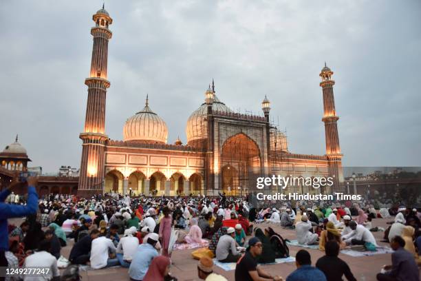 Muslims people break their fast on the first day of Ramadan Roza iftar in front of Illuminated Jama Masjid of Eid-ul-Fitr festival, on March 24, 2023...