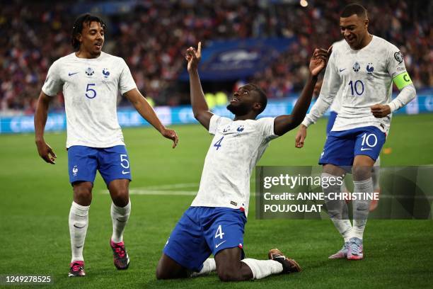 France's defender Dayot Upamecano celebrates with France's defender Jules Kounde and France's forward Kylian Mbappe after scoring his team's second...