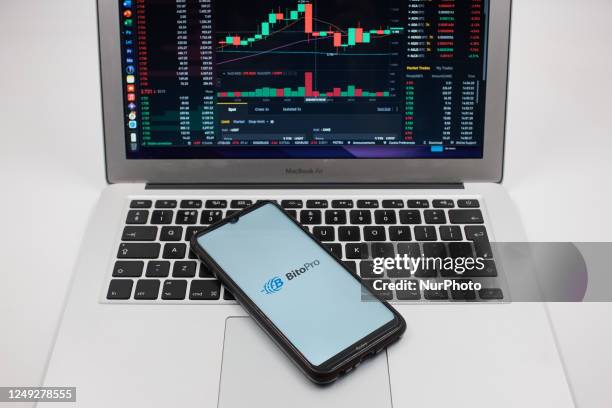 In this photo illustration a BitoPro logo seen displayed on a smartphone screen and an Exchange graph on a MacBook screen in Athens, Greece on March...