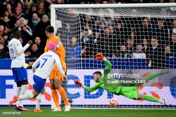 France's forward Antoine Griezmann kicks to score his team's first goal during the UEFA Euro 2024 qualification football match between France and...