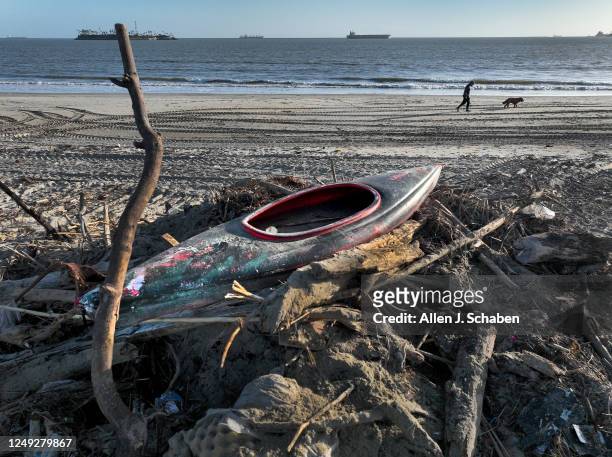 Long Beach, CA A kayak is among a variety of debris scooped up into a large pile of trash that floated up on the beach from the Los Angeles River...