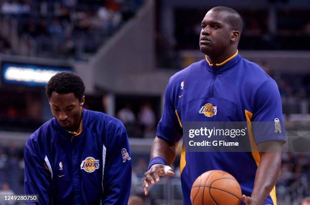 Kobe Bryant and Shaquille O'Neal of the Los Angeles Lakers warm up before the game against the Washington Wizards on April 2, 2002 at the MCI Center...