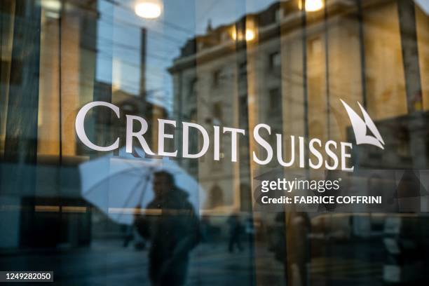 This photograph taken on March 24, 2023 in Geneva, shows a sign of Credit Suisse bank. - The marriage of UBS and Credit Suisse was hastily arranged...