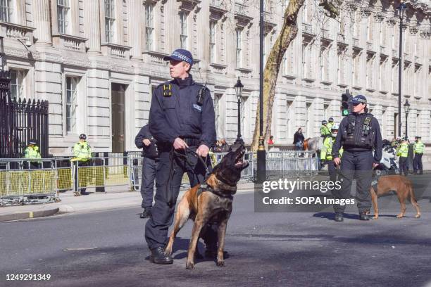 Police dog barks at protesters during the demonstration outside Downing Street. Crowds of British Israelis staged a protest against Benjamin...