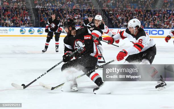 Alex Tuch of the Buffalo Sabres controls the puck against John Marino of the New Jersey Devils during an NHL game on March 24, 2023 at KeyBank Center...