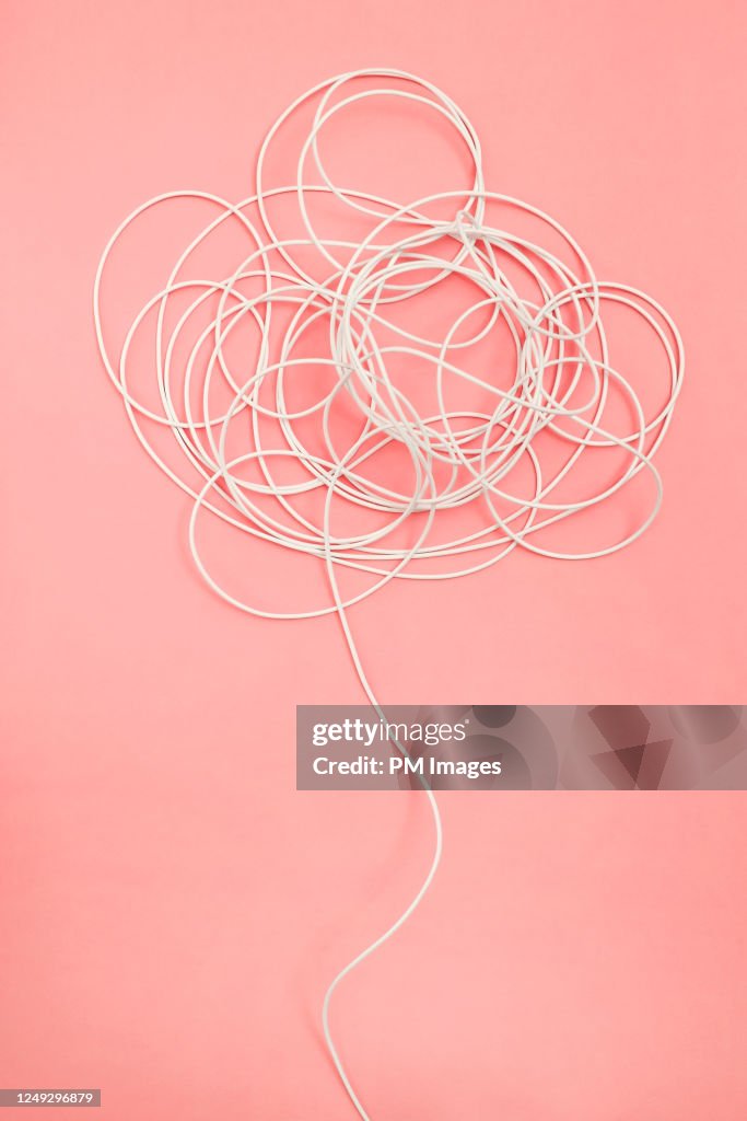 Tangle of white wire on pink