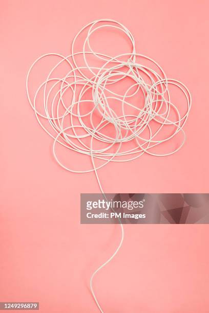 tangle of white wire on pink - electrical failure stock pictures, royalty-free photos & images